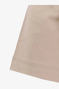 Beige boss men’s cotton shirt showing neat matching stitching along the hem on beige cotton fabric