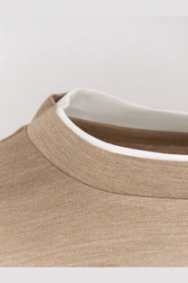 Beige ribbed knit turtleneck with contrasting white lining paired with BOSS men’s brown cotton and silk shirt