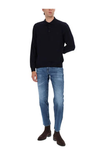 Black knit polo shirt with textured pattern and three-button placket paired with BOSS men’s jeans Maine blue