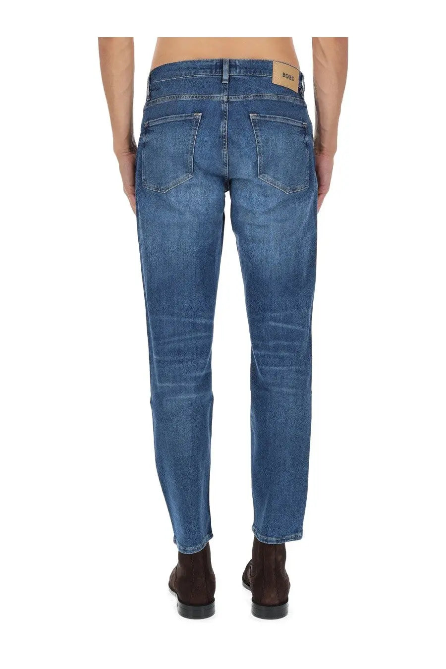 Blue denim jeans with classic five-pocket design and brown leather brand patch at waistband by BOSS men’s jeans Maine blue