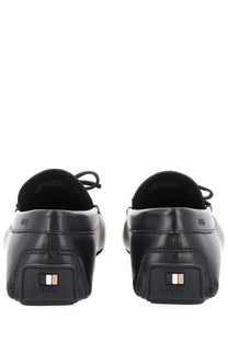 Back view of boss men’s moccasin black leather loafers with a sleek minimalist design and embossed boss logo on heel