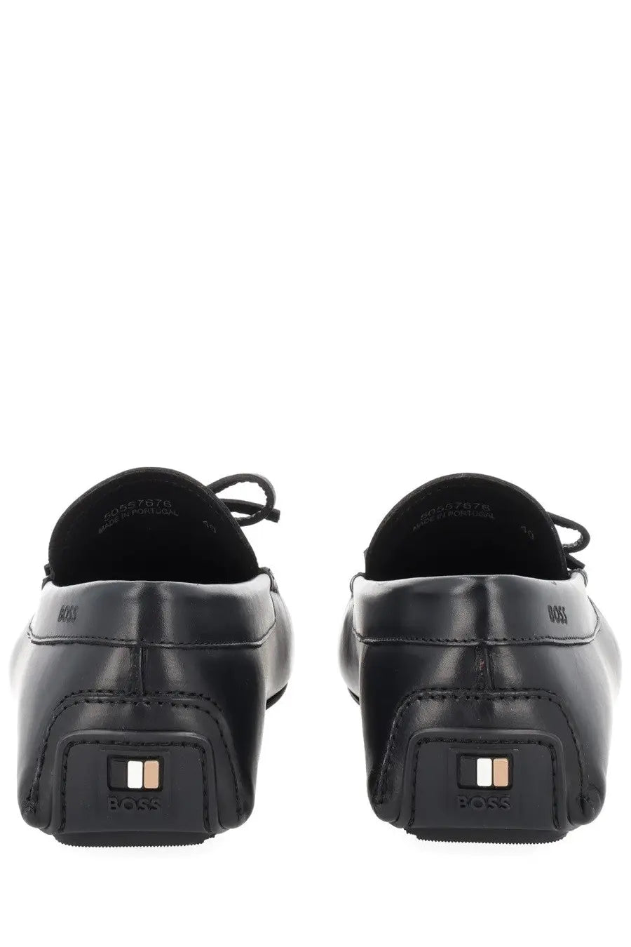 Black leather loafers with a sleek minimalist design and boss logo embossed on the heel shown from the back side