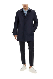 Navy blue trench coat with classic collar and button closure featured with BOSS Men’s George blue pants