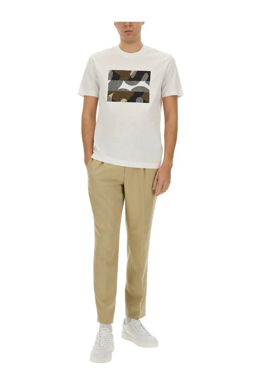 White short-sleeved t-shirt with rectangular brown and black abstract print paired with boss men’s beige pants perin