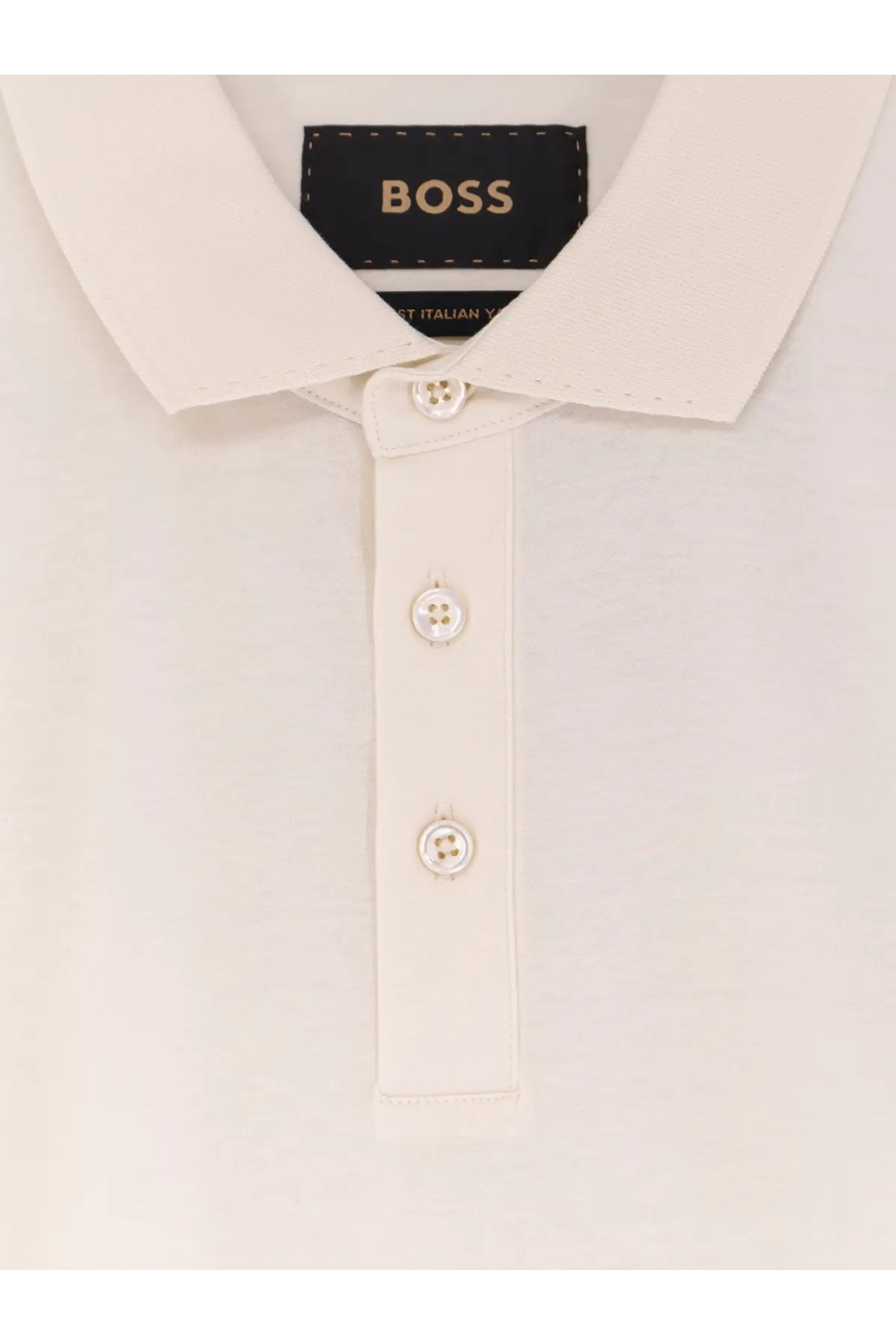 A cream-colored boss men’s perry cotton polo shirt with classic collar and matching buttons