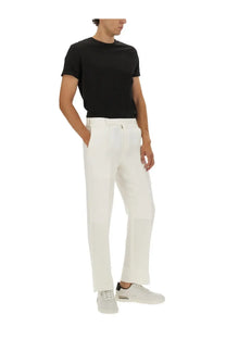White tailored trousers with a clean straight-leg cut and subtle creasing paired with a boss men’s shirt beckham black