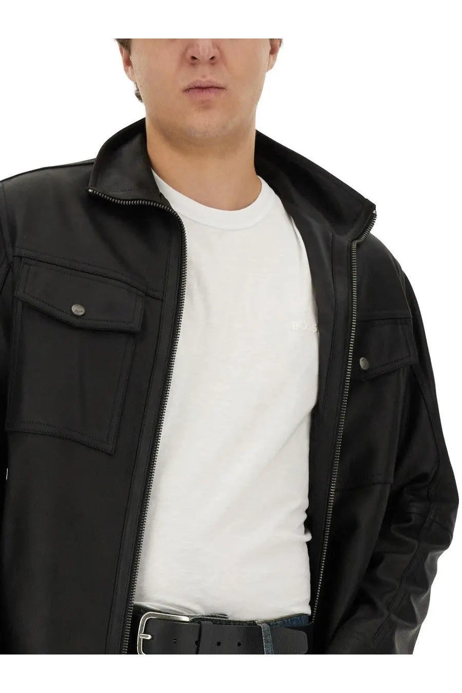 Black leather jacket with silver zippers and buttoned flap pockets shown alongside boss men’s cotton white shirt