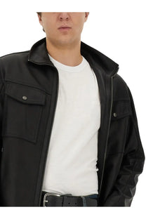 Black leather jacket with silver zippers and buttoned flap pockets shown alongside boss men’s cotton white shirt