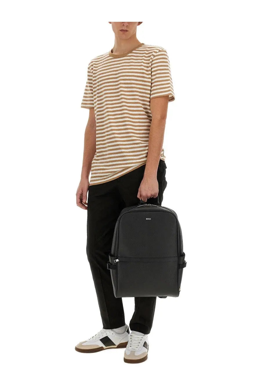 Black leather backpack with minimalist design and subtle logo paired with boss men’s striped beige shirt