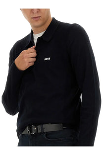 Black knit polo shirt with subtle textured pattern and white boss logo embroidered on left chest for men