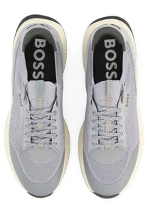 Light gray mesh boss men’s ttnm evo sneaker with white and black sole and boss logo on the insole