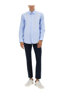 Light blue long-sleeved button-down shirt made of soft twill fabric for men paired with boss blue pants