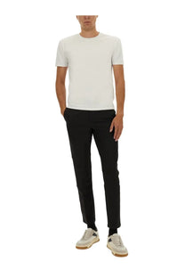 A minimalist white crew neck t-shirt with short sleeves made from smooth lightweight fabric paired with boss black pants