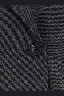 Black button with subtle sheen on textured herringbone wool blend dark gray blazer from BOSS women’s jafleni line