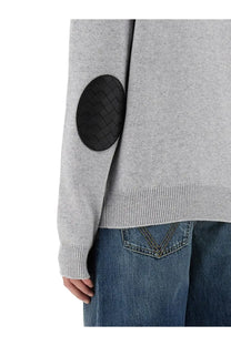 Bottega Veneta men’s white cashmere sweater with gray knit sleeves and black woven leather elbow patch visible from back
