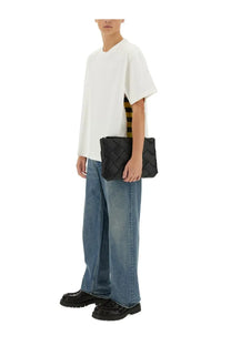 Black woven leather clutch bag paired with bottega veneta men’s checkered white soft cotton jersey shirt