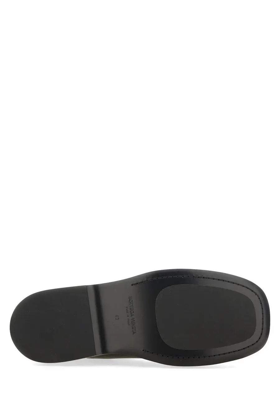 Black leather sole with matte finish and embossed branding on bottega veneta men’s chelsea boot torino black