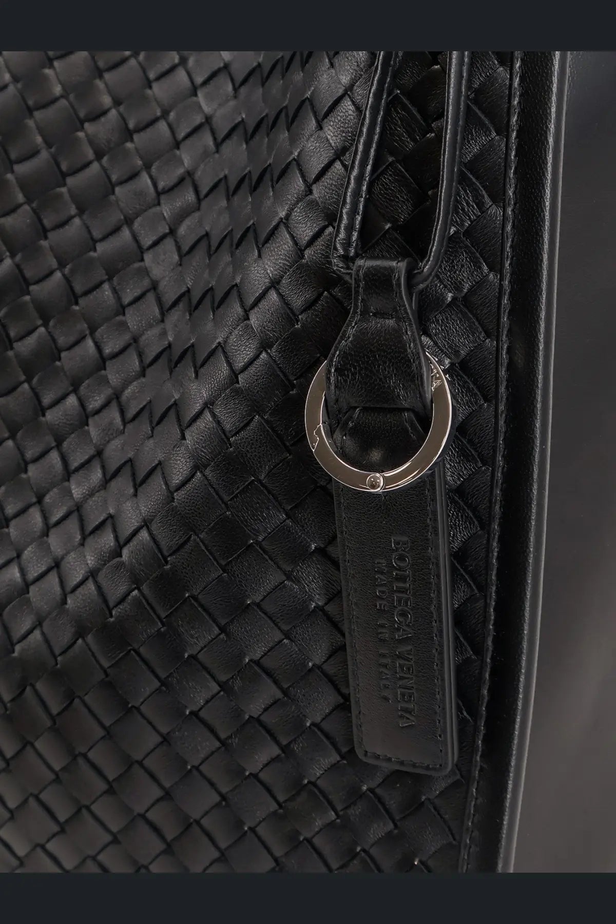 Black woven leather keychain with silver-toned ring and embossed bottega veneta logo tag for mens corriere bag