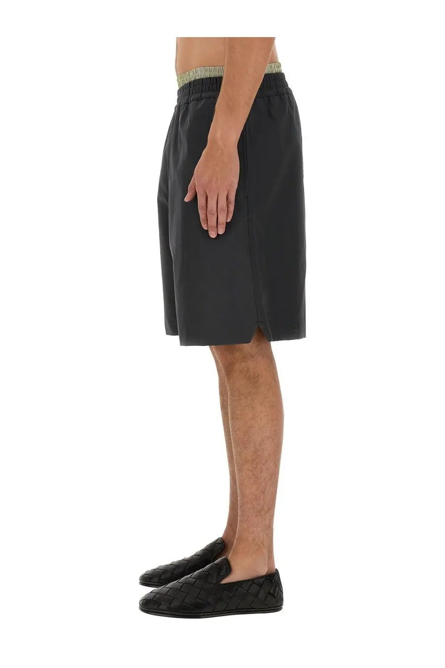 Black woven leather loafers with textured interlaced pattern paired with bottega veneta men’s grey cotton shorts