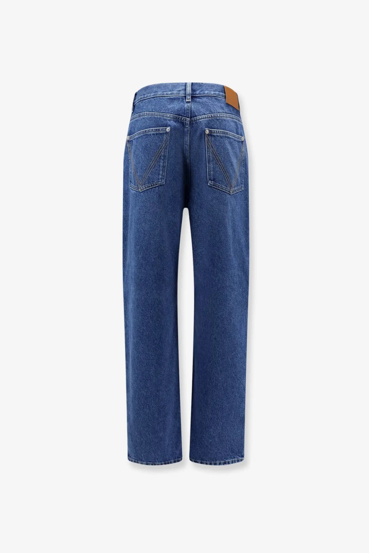 Blue denim straight-leg jeans with medium indigo wash and brown leather patch at waistband by Bottega Veneta