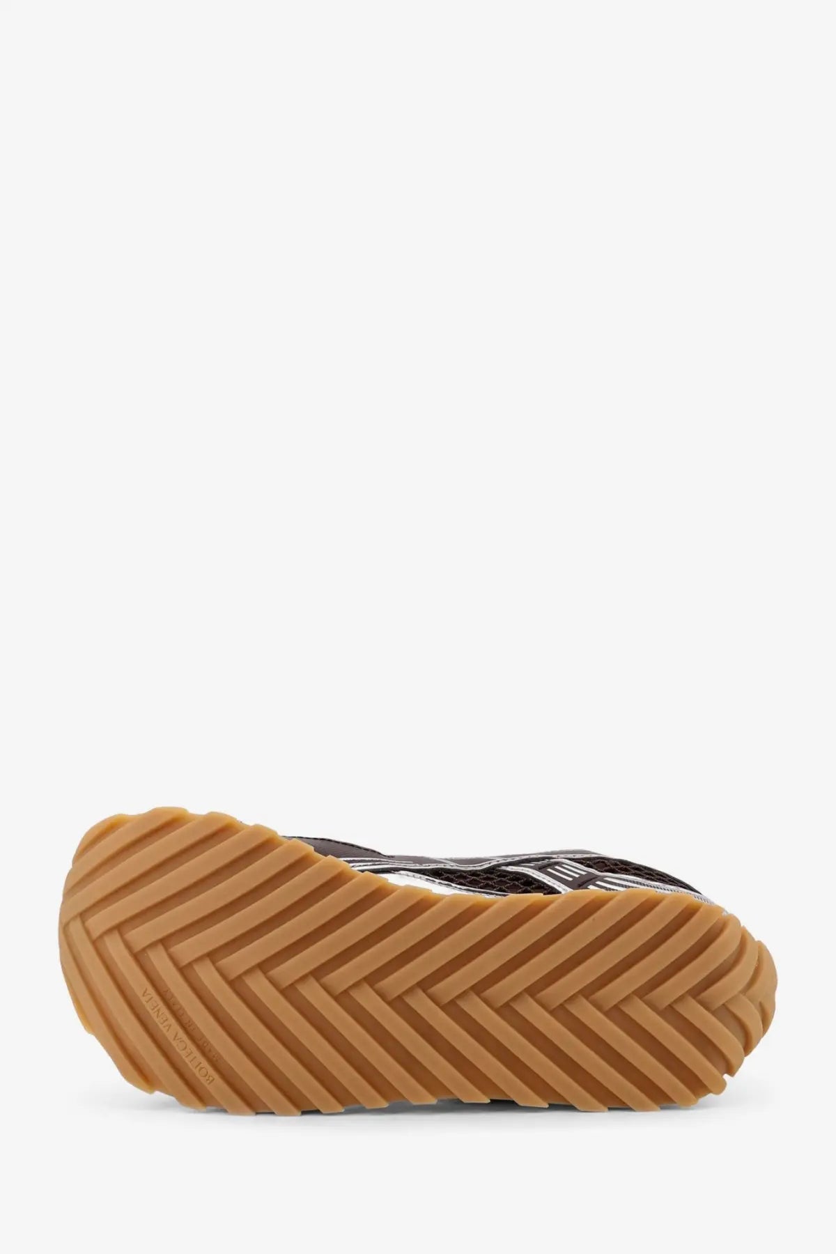 Bottega Veneta men’s orbit mesh sneaker in black and white with tan rubber sole and herringbone tread pattern