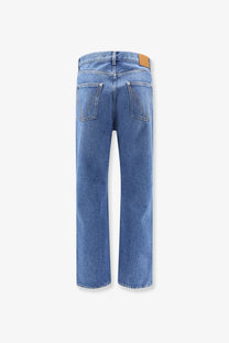 Bottega Veneta men’s blue straight-leg cotton jeans with a tan leather brand patch at the waistband back view