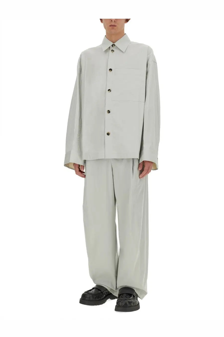 A minimalist off-white button-up shirt with a structured collar and long sleeves paired with bottega veneta grey silk and cotton pants