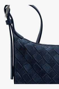 A navy blue bottega veneta intrecciato leather shoulder bag with black leather handle from the men’s traveler collection