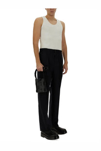 Black woven leather mini handbag with top handle paired with bottega veneta men’s blue wool pants