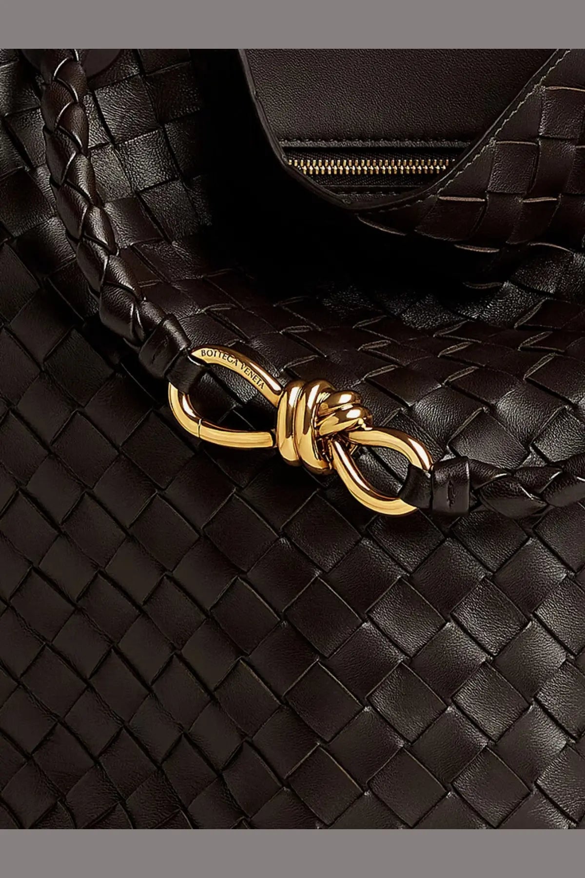 Bottega Veneta women’s andiamo bucket leather crossbody bag in black woven leather with gold-tone knot clasp
