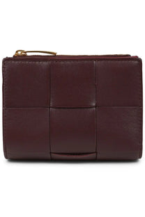 Bottega Veneta women’s bi fold wallet in brown burgundy leather with woven grid pattern and gold tone zipper