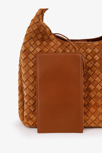 A tan leather wallet with zipper closure and subtle embossed branding complements bottega veneta campana bag brown