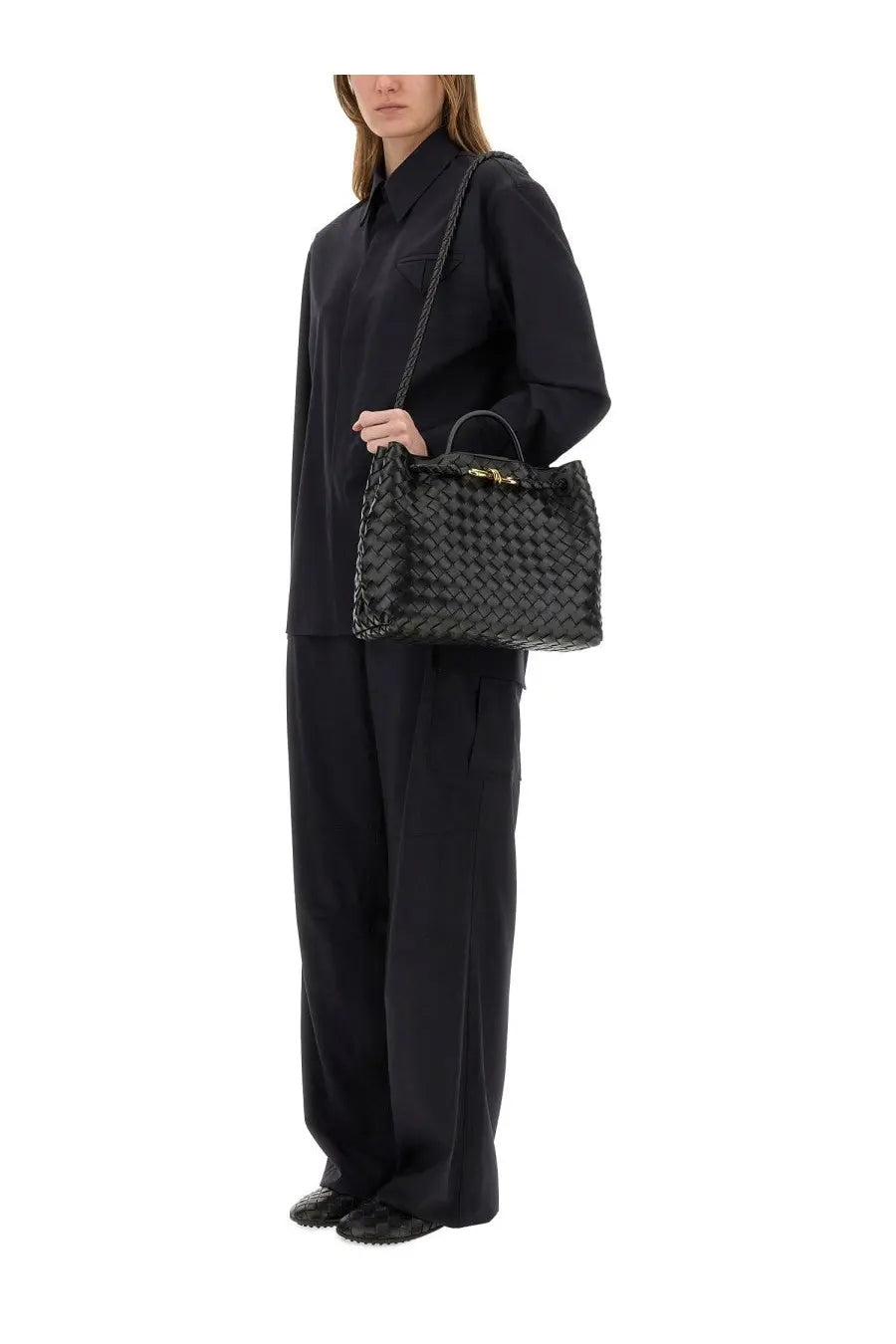 Black woven leather handbag with gold-tone hardware paired with bottega veneta women’s blue cargo pants