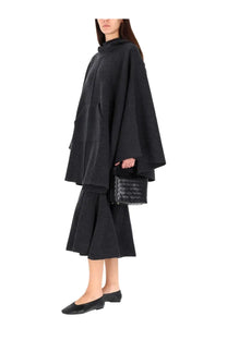 Black woven leather handbag with structured rectangular shape and top handle featured with bottega veneta cashmere coat gray