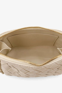 Beige woven leather clutch with gold-tone zipper and interior branding from bottega veneta concert pouch bag