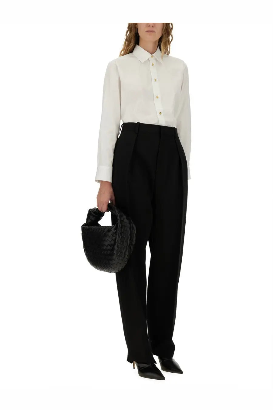 Black woven leather handbag with distinctive knotted top handle shown alongside Bottega Veneta white cotton poplin shirt