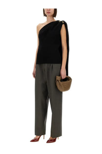 A tan woven basket bag with a knotted top handle paired with bottega veneta womens black crepe tops
