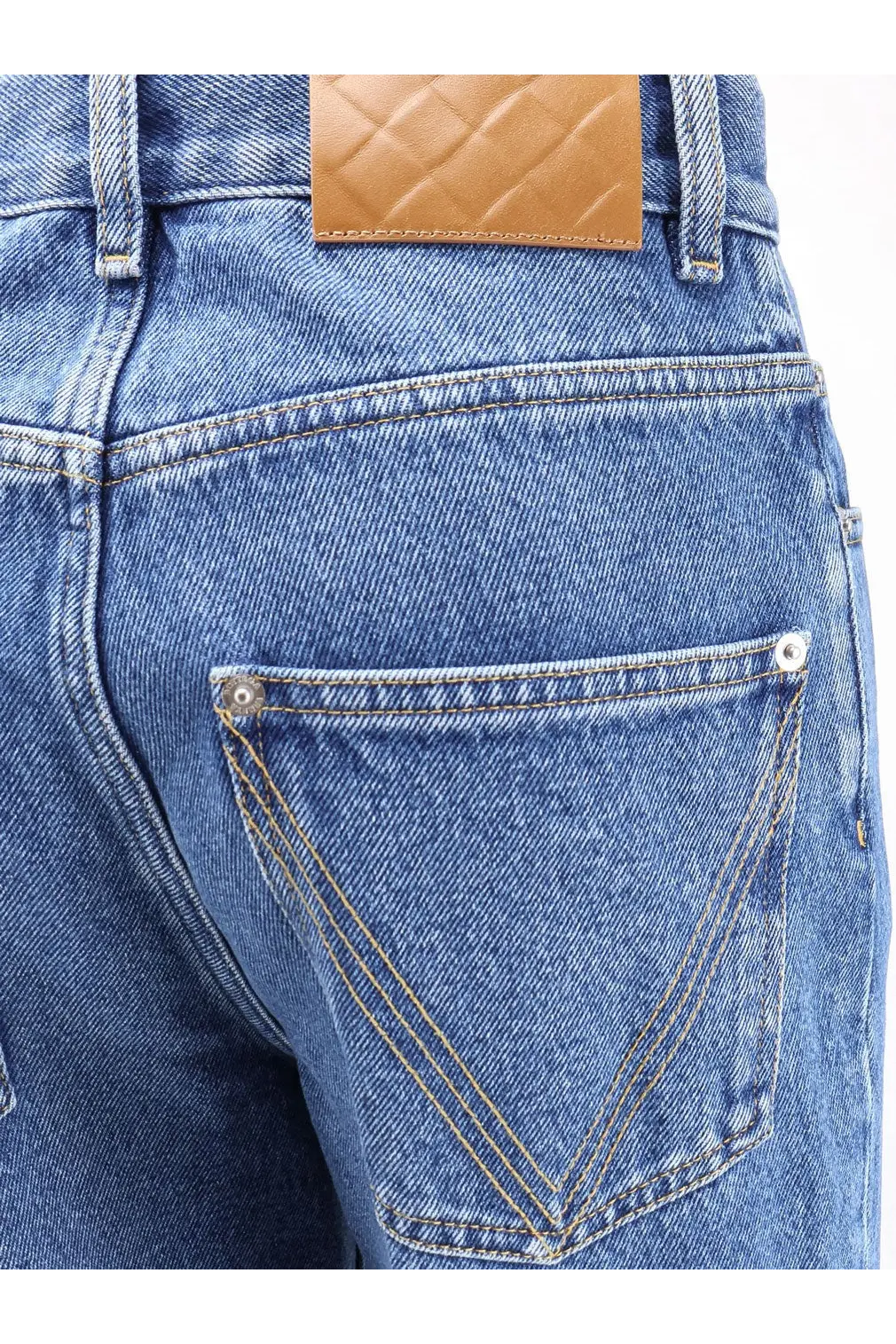 Blue denim bottega veneta womens flared cotton jeans back view with tan quilted leather patch and silver rivets