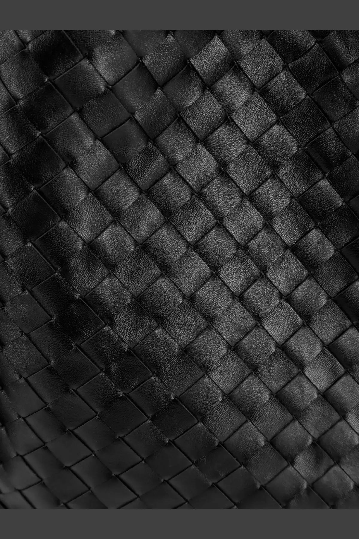 Black woven leather strap with tight diamond pattern on bottega veneta women’s hop hobo leather shoulder bag