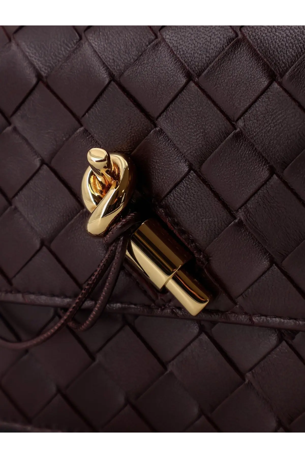 Dark brown woven leather clutch with gold-tone metal clasp for women’s crossbody bag by bottega veneta