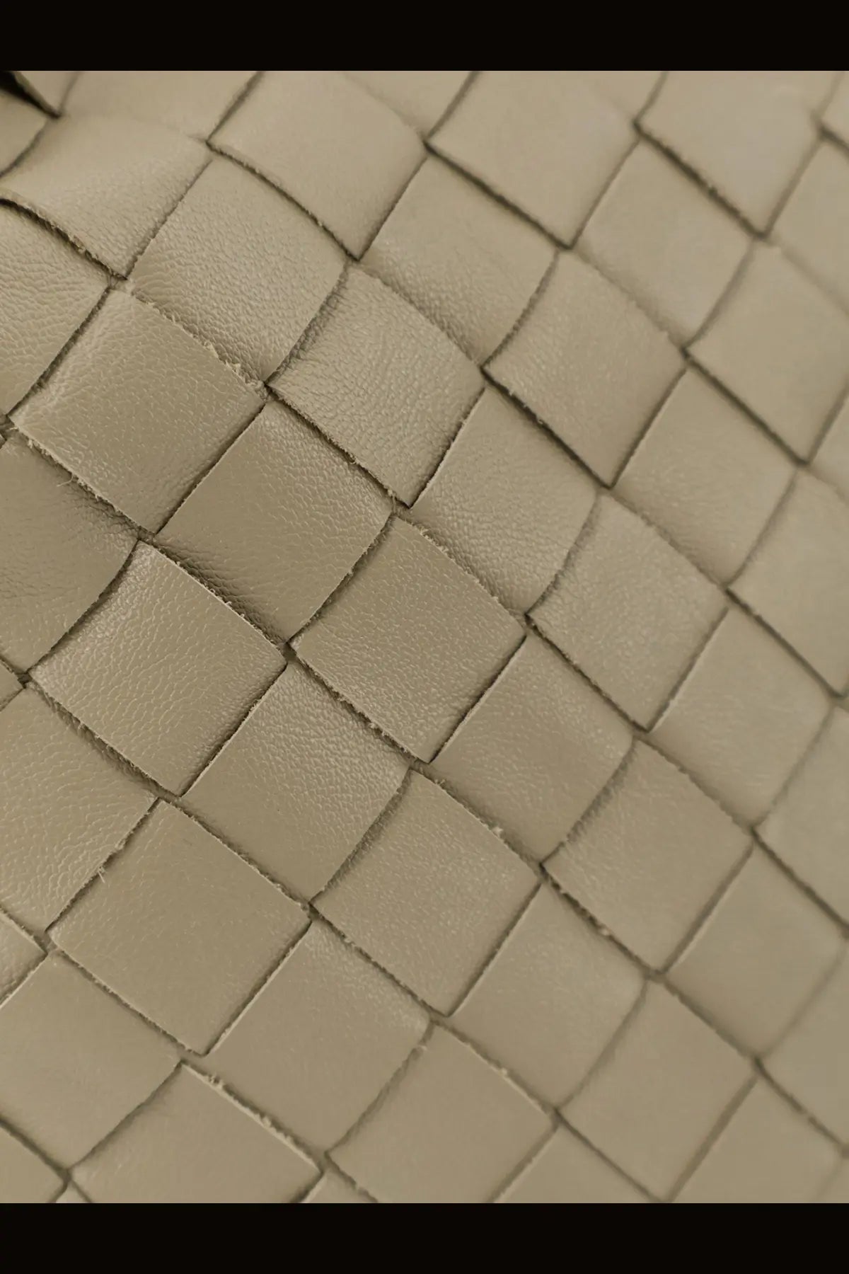 Beige woven leather strap with structured interlaced pattern on bottega veneta womens mini hop leather crossbody bag