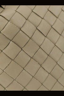 Beige woven leather strap with structured interlaced pattern on bottega veneta womens mini hop leather crossbody bag