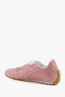 Bottega Veneta women’s orbit flash leather sneaker in pink with white laces and tan rubber sole