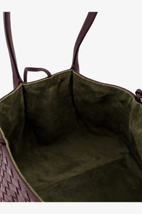 A Bottega Veneta women’s deep burgundy woven leather tote bag with olive green suede interior