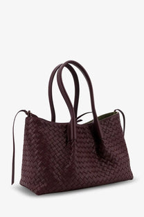 A deep burgundy woven leather tote bag with a zigzag pattern and structured handles by Bottega Veneta