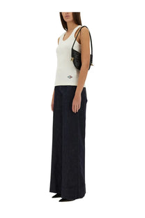Black quilted shoulder bag with gold-tone hardware paired with bottega veneta ribbed cotton jersey top white