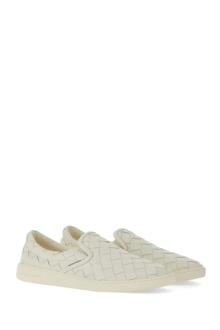 Cream-colored woven leather slip-on sneakers with minimalist design and subtle branding by Bottega Veneta women’s Sawyer sneaker white