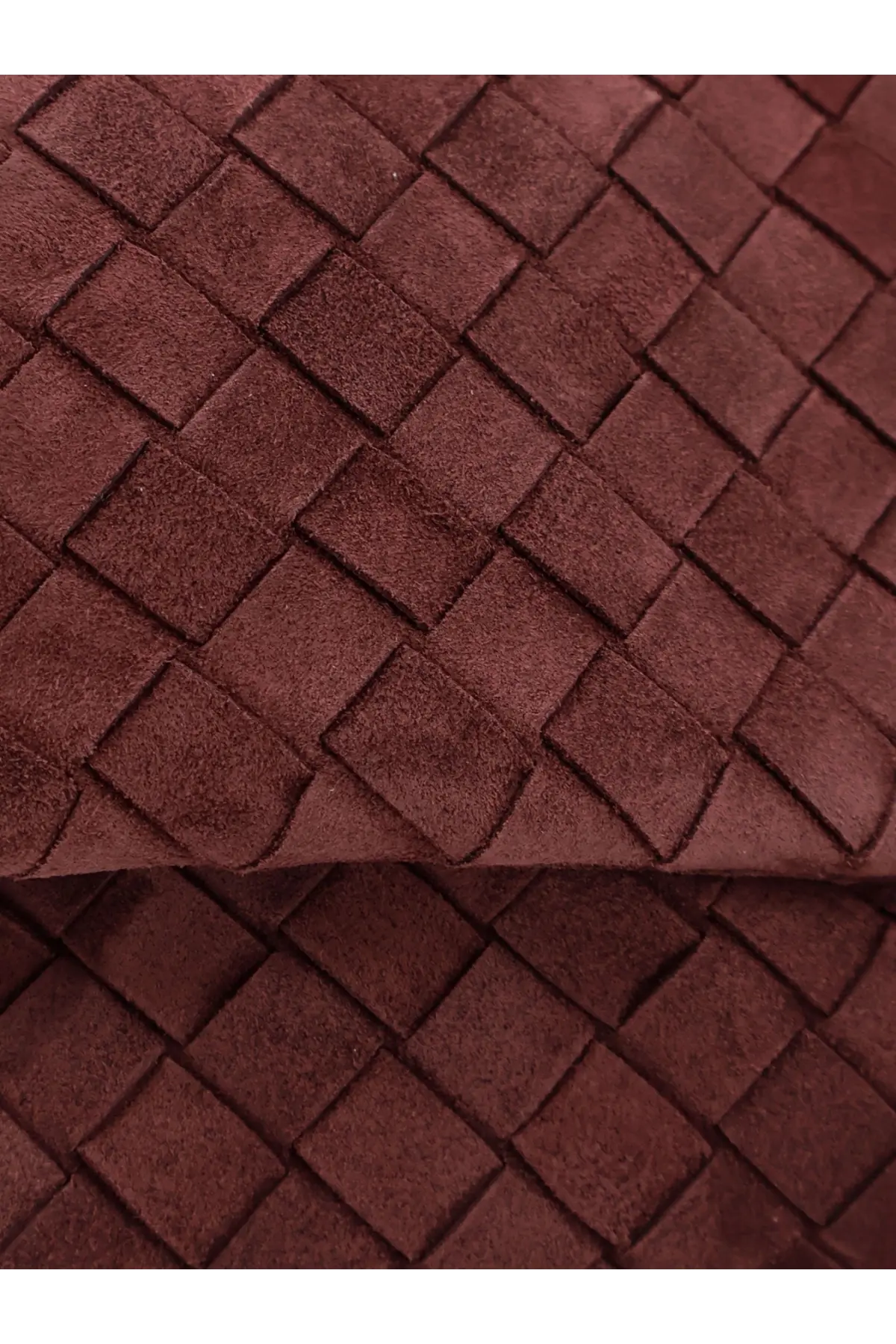 A rich burgundy suede woven strap with a distinctive interlocking square pattern on bottega veneta womens suede giorno crossbody bag deepmahogany