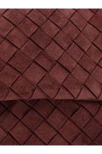 A rich burgundy suede woven strap with a distinctive interlocking square pattern on bottega veneta womens suede giorno crossbody bag deepmahogany