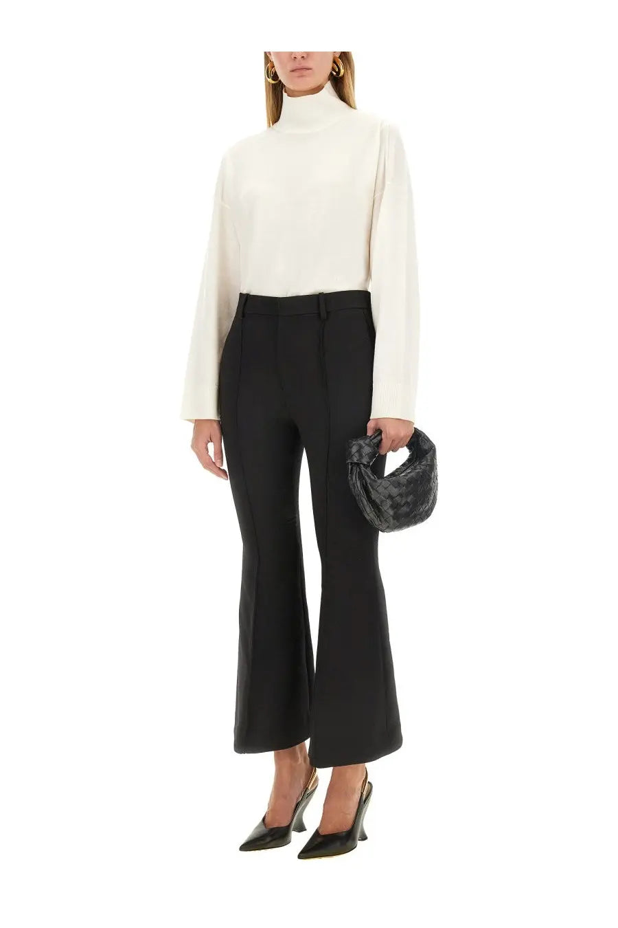 Black textured woven handbag with a distinctive twisted knot handle paired with bottega veneta women’s wool pants black